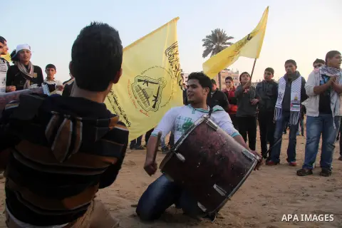 Palestinian supporters of Fatah movement hold the party's flags during a rally in Gaza city on December 31, 2012. The Gaza branch of Palestinian president Mahmud Abbas's Fatah party said on Friday it will mark its annive...