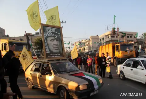 Palestinian supporters of Fatah movement hold the party's flags during a rally in Gaza city on December 31, 2012. The Gaza branch of Palestinian president Mahmud Abbas's Fatah party said on Friday it will mark its annive...