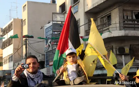 Palestinian supporters of Fatah movement hold the party's flags during a rally in Gaza city on December 31, 2012. The Gaza branch of Palestinian president Mahmud Abbas's Fatah party said on Friday it will mark its annive...