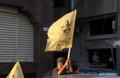 A Palestinian supporter of Fatah movement holds the party's flag during a rally in Gaza city on December 31, 2012. The Gaza branch of Palestinian president Mahmud Abbas's Fatah party said on Friday it will mark its anniv...