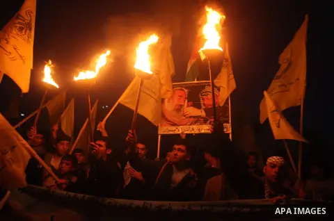 Palestinian supporters of Fatah movement hold the party's flags during a rally in Gaza city on December 31, 2012. The Gaza branch of Palestinian president Mahmud Abbas's Fatah party said on Friday it will mark its annive...