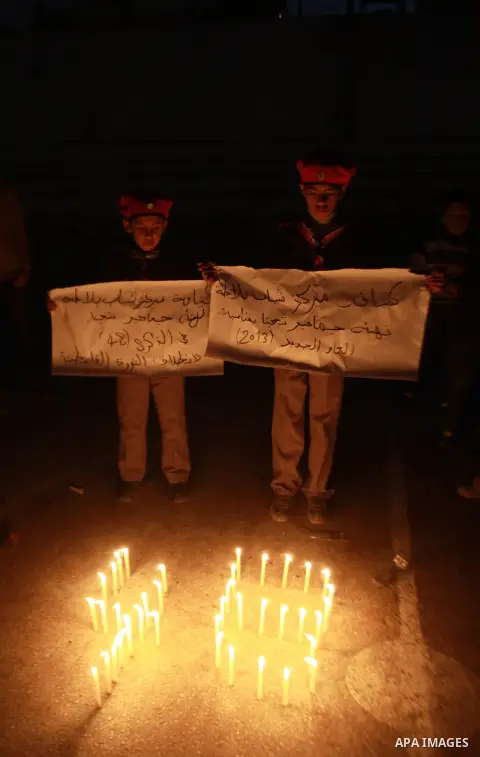Palestinian supporters of Fatah movement place candles during a rally on the eve of the 48th anniversary of the formation on the Fatah movement, on December 31, 2012, in the West Bank city of Nablus. The Fatah anniversar...