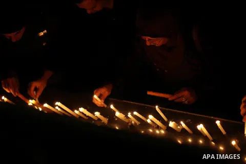 Egyptian activists light candles at the entrance of the Journalist's Syndicate in Cairo on December 31, 2012, during a rally to commemorate the anniversary of the car bomb attack on the al-Qiddissine (The Saints) church...