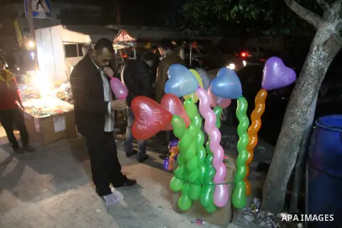 A Palestinian vendor sells balloons, during take part in celebrations of the New Year's Eve festivities in the Gaza city of on Dec. 31, 2012. Photo by Ezz al-Zanoon