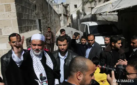 Palestinian Prime Minister in Gaza Strip, Ismail Haniya, flashes the victory sign following Friday prayers in Gaza City on March 8, 2013. Hamas and Islamic Jihad called a march in solidarity with the Al-Aqsa Mosque in Je...