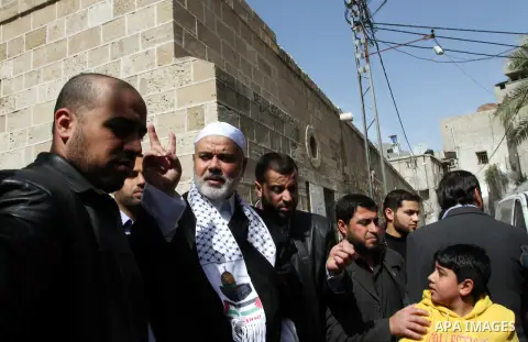 Palestinian Prime Minister in Gaza Strip, Ismail Haniya, flashes the victory sign following Friday prayers in Gaza City on March 8, 2013. Hamas and Islamic Jihad called a march in solidarity with the Al-Aqsa Mosque in Je...