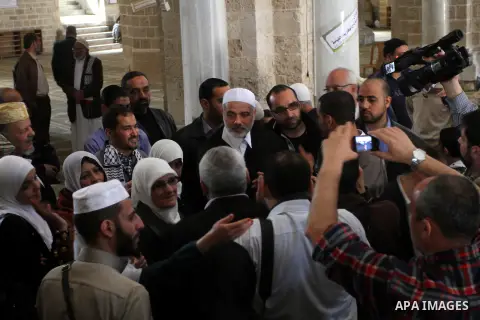 Palestinian Prime Minister in Gaza Strip, Ismail Haniya, flashes the victory sign following Friday prayers in Gaza City on March 8, 2013. Hamas and Islamic Jihad called a march in solidarity with the Al-Aqsa Mosque in Je...