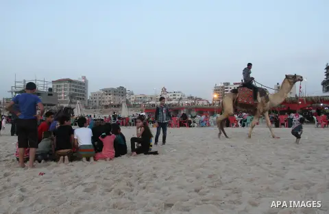 Palestinians enjoy swimming in the sea at Gaza beach during Friday holiday in Gaza city, May 03, 2013. Gazans escape to the beach and out from their homes during heat wave and power outages. Photo by Emad Nassar