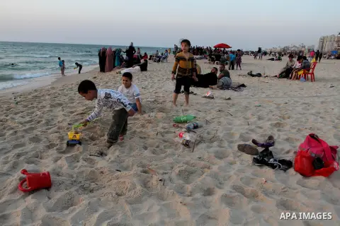 Palestinians enjoy swimming in the sea at Gaza beach during Friday holiday in Gaza city, May 03, 2013. Gazans escape to the beach and out from their homes during heat wave and power outages. Photo by Emad Nassar