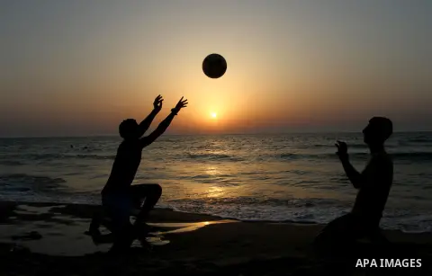Palestinian boys enjoy playing in the sea at Gaza beach during hot weather in Gaza city, May 03, 2013. Gazans escape to the beach and out from their homes during heat wave and power outages. Photo by Emad Nassar
