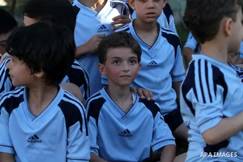 Palestinian boys pose for the camera as the take part in training exercises at a soccer club during their summer holiday in Gaza city on June 19, 2013. Photo by Ashraf Amra