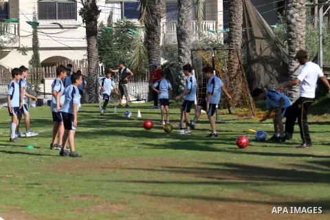 Palestinian boys play soccer in training exercises at a soccer club during their summer holiday in Gaza city on June 19, 2013. Photo by Ashraf Amra