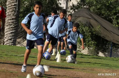 Palestinian boys play soccer in training exercises at a soccer club during their summer holiday in Gaza city on June 19, 2013. Photo by Ashraf Amra