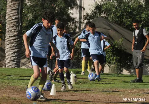 Palestinian boys play soccer in training exercises at a soccer club during their summer holiday in Gaza city on June 19, 2013. Photo by Ashraf Amra