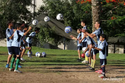 Palestinian boys play soccer in training exercises at a soccer club during their summer holiday in Gaza city on June 19, 2013. Photo by Ashraf Amra