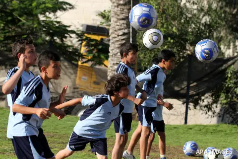Palestinian boys play soccer in training exercises at a soccer club during their summer holiday in Gaza city on June 19, 2013. Photo by Ashraf Amra