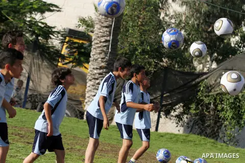 Palestinian boys play soccer in training exercises at a soccer club during their summer holiday in Gaza city on June 19, 2013. Photo by Ashraf Amra