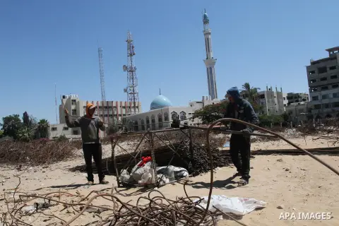 Palestinian laborers adjust used steel bars, at a site of an old prison known as al-Saraya that was destroyed by the Isreali airstrikes during the conflict between Israel and Gaza militants, in Gaza city July 4, 2013. Pa...