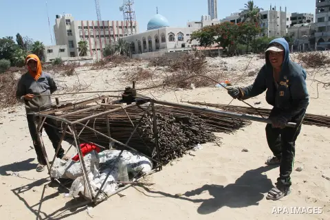 Palestinian laborers adjust used steel bars, at a site of an old prison known as al-Saraya that was destroyed by the Isreali airstrikes during the conflict between Israel and Gaza militants, in Gaza city July 4, 2013. Pa...