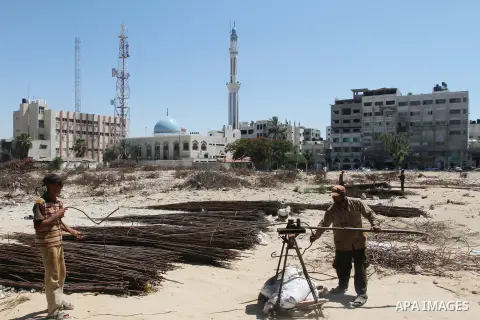 Palestinian laborers adjust used steel bars, at a site of an old prison known as al-Saraya that was destroyed by the Isreali airstrikes during the conflict between Israel and Gaza militants, in Gaza city July 4, 2013. Pa...