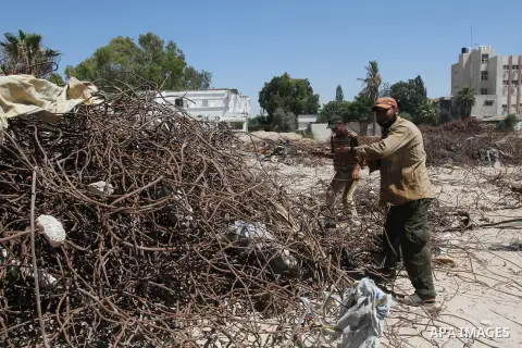 Palestinian laborers collect used steel bars, at a site of an old prison known as al-Saraya that was destroyed by the Isreali airstrikes during the conflict between Israel and Gaza militants, in Gaza city July 4, 2013. P...