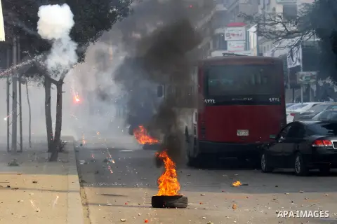 Supporters of Muslim Brotherhood and ousted Egyptian President Mohamed Mursi clash with riot police and opponents on January 3, 2014. The protests came after an Islamist alliance backing Morsi called for demonstrations a...
