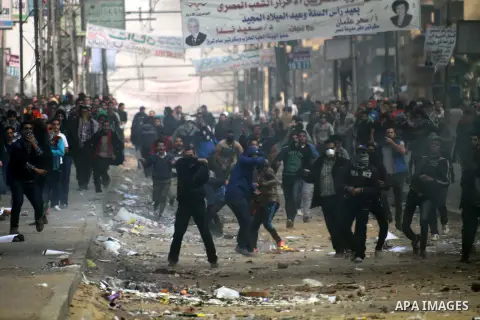 Supporters of Muslim Brotherhood and ousted Egyptian President Mohamed Mursi clash with riot police and opponents on January 3, 2014. The protests came after an Islamist alliance backing Morsi called for demonstrations a...