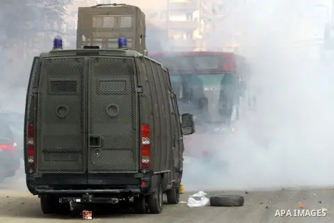 Egyptian anti-riot police forces advance amid smoke and burning objects allegedly set on fire by supporters of the Muslim Brotherhood during clashes in Cairo on January 3, 2014. The protests came after an Islamist allian...