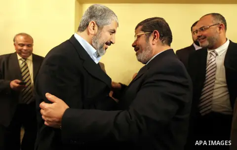 FILE PHOTO: A handout photograph released by the Hamas Press Office shows Leaders of the newly formed Freedom and Justice Party, President Mohammed Morsy, meets with Palestinian Hamas leader Khaled Meshaal (R) in Cairo,...