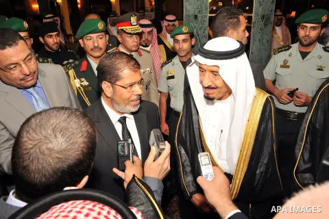 FILE PHOTO: Egyptian President Mohamed Morsi (CL) speaks to reporters alongside Saudi Crown Prince Salman bin Abdulaziz (CR) upon arrival in Jeddah on July 11, 2012. Former President Mohamed Morsi died on Monday in court...