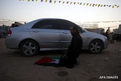 A Palestinian man prays at al-Saraya square during the preparations for the ceremony of the 48th anniversary of the founding of Fatah movement in Gaza city, on January 3, 2012. The anniversary commemorates the first oper...
