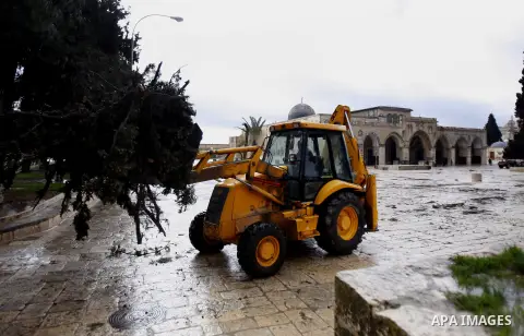 Palestinians try to remove a tree downed by strong winds in front of the Dome of the Rock on the compound know to Muslims as al-Haram al-Sharif during stormy weather in Jerusalem's Old City January 7, 2013. Photo by Mahf...