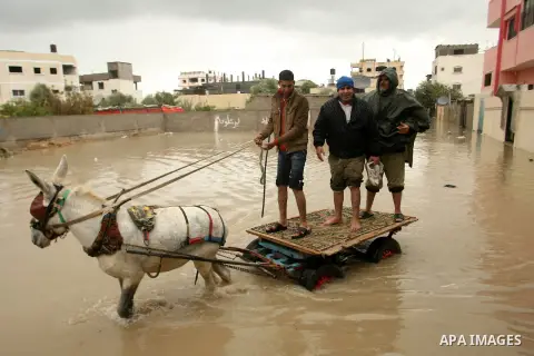 Palestinians ride a cart through floodwater in Rafah refugee camp in the southern Gaza Strip on Jan. 09, 2013. A storm has hit the eastern Mediterranean coast and heavy rains with flooding are forecast in Israel and the...