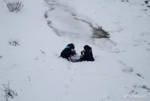 Palestinians play in the snow in the West Bank city of Ramallah January 10, 2013. At least 17 people have died due to a storm in Lebanon, Jordan, Turkey, Israel and the Palestinian territories. Meteorological agencies in...