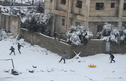 Palestinians play in the snow in the West Bank city of Ramallah January 10, 2013. At least 17 people have died due to a storm in Lebanon, Jordan, Turkey, Israel and the Palestinian territories. Meteorological agencies in...
