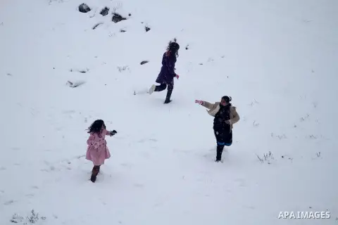 Palestinians play in the snow in the West Bank city of Ramallah January 10, 2013. At least 17 people have died due to a storm in Lebanon, Jordan, Turkey, Israel and the Palestinian territories. Meteorological agencies in...