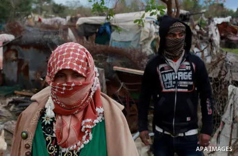 Palestinians bedouin stand outside their shack on a windy winter day in the central Gaza Strip January 10, 2013. A storm has hit the eastern Mediterranean coast and heavy rains with flooding are forecast in Israel and th...