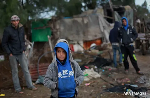 Palestinians bedouin stand outside their shack on a windy winter day in the central Gaza Strip January 10, 2013. A storm has hit the eastern Mediterranean coast and heavy rains with flooding are forecast in Israel and th...