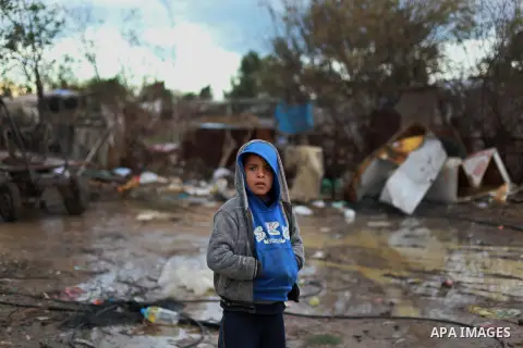 A Palestinian bedouin child stands outside his shack on a windy winter day in the central Gaza Strip January 10, 2013. A storm has hit the eastern Mediterranean coast and heavy rains with flooding are forecast in Israel...