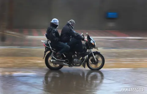 Palestinians ride motorcycle through floodwater in the central Gaza Strip January 10, 2013. A storm has hit the eastern Mediterranean coast and heavy rains with flooding are forecast in Israel and the Palestinian territo...