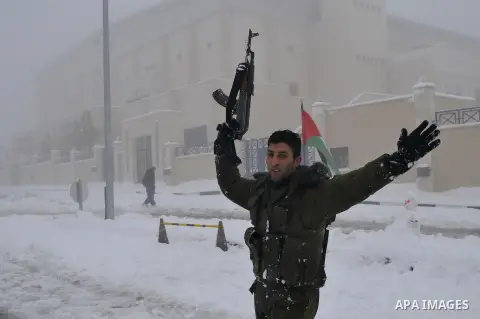 Palestinian security personnel engage in a snowball fight near their headquarters in the West Bank city of Hebron 10 January 2013. The higher elevations in the Palestinian Authority areas and Israel, including Jerusalem,...