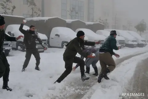 Palestinian security personnel engage in a snowball fight near their headquarters in the West Bank city of Hebron 10 January 2013. The higher elevations in the Palestinian Authority areas and Israel, including Jerusalem,...