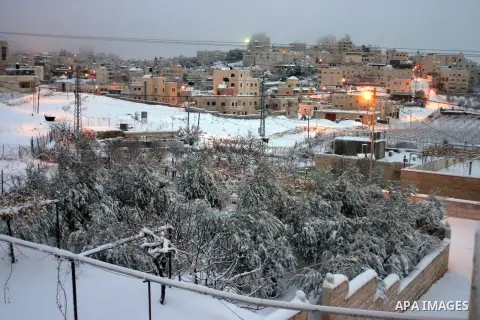 A general view shows the snow falls in the West Bank city of Hebron on January 10, 2013. Abnormal storms, which for four days have blasted the Middle East with rain, snow and hail, leave swathes of Israel and Jordan unde...