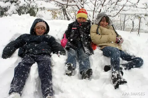 Palestinian children in the snow balls in the West Bank city of Hebron on January 10, 2013. Abnormal storms, which for four days have blasted the Middle East with rain, snow and hail, leave swathes of Israel and Jordan u...