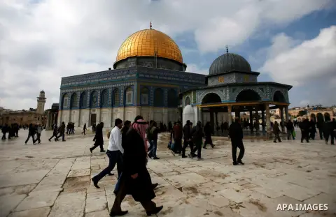 Palestinian worshippers walk in front of the Dome of the Rock mosque following Friday prayers at al-Aqsa mosque, Islam's third holiest site, in Jerusalem's old city on January 11, 2013. Photo by Mahfouz Abu Turk