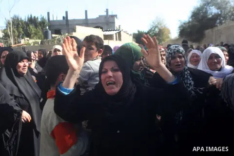 Relatives of Palestinian Mustafa Abu Jarad mourn during his funeral in the northern Gaza Strip January 15, 2013. Palestinian medical officials accused Israeli soldiers of killing Abu Jarad, a 21-year-old farmer, in the G...