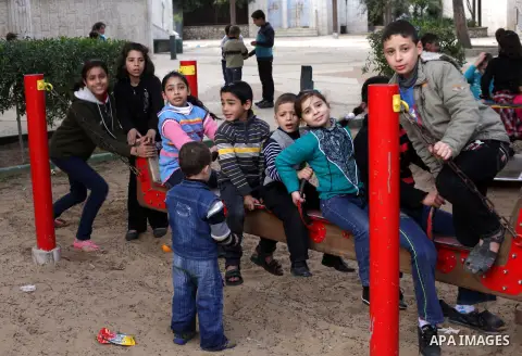 Palestinian children play at a park during the semester break, in Gaza city on 16 January 2013. Photo by Ashraf Amra