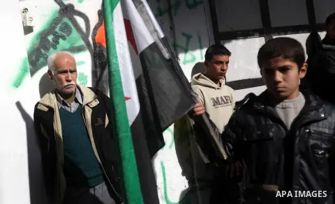 Palestinians wave a Syrian opposition flag during a rally organized by Hamas movement in the northern Gaza Strip, in support of the Syrian revolution, January 18, 2013. Photo by Majdi Fathi
