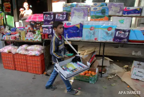 A Palestinian child sells toothpastes at al-Zawiya popular market in Gaza city, January 20, 2013. Photo by Ezz al-Zanoon