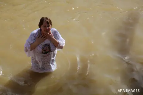 Orthodox pilgrims entering the water on the West Bank side of the Jordan River for the baptismal ceremony at the site known as Qasr el-Yahud near the city of Jericho, on 20 January 2013. Thousand of Orthodox pilgrims flo...